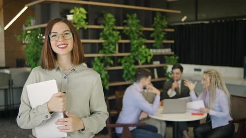 Confident Woman with Laptop in Modern Office Setting