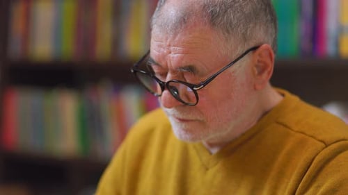 Knowledge Gazer Front View of Senior Man Amid Library Stacks