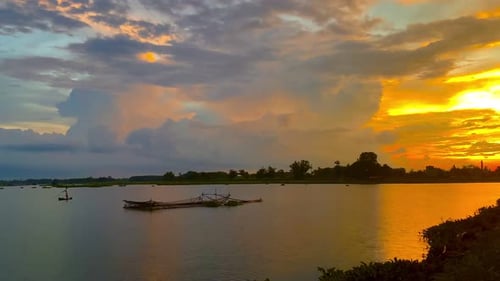 The beautiful sunset over the calm waters of the lake makes for a perfect view