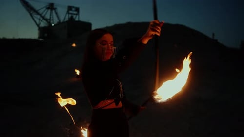 Woman Performs Fire Dance at Night