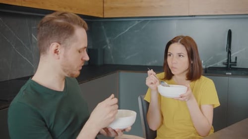 Couple Eating Cereal Together in Modern Kitchen
