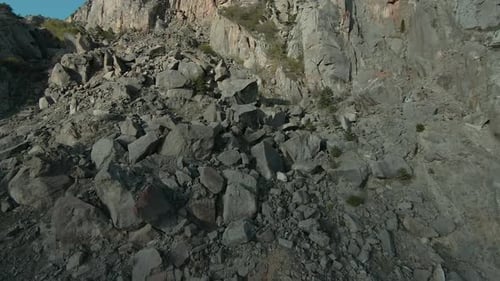 Aerial View of a Stone Mountain Slope Shot Rock Cliff with Stones on a Sunny Day