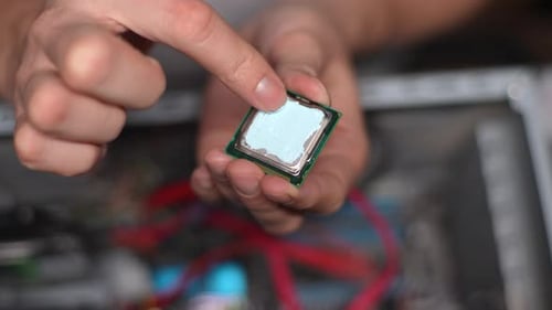 Top View of Technician Male Applying and Smearing New Thermal Paste to PC CPU Processor Chip in