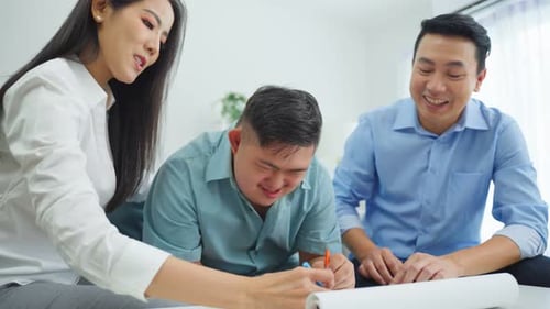 Family Smiling Together Drawing on Table Indoors