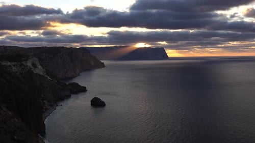 Sea Landscape with Rocky Coastline on Sunset Time with Cloudy Sky