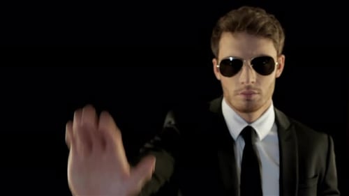 Man in Suit Holds Hand Up to Stop