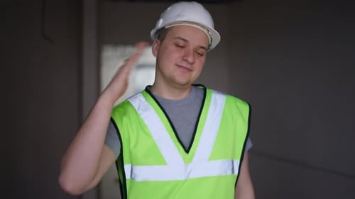 Cheerful Positive Builder Dancing in Building Under Construction Having Fun on Break