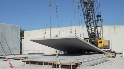 Crane Tilting Concrete Panel at a Construction Site