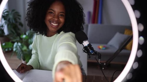 Engaging Young Woman Vlogging with Ring Light and Microphone