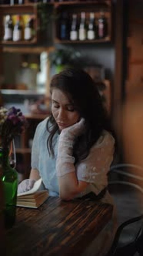 A Thoughtful Woman Sitting in a Charming Vintage Cafe Enjoying a Book in Peaceful Surroundings