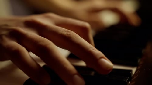 Fingers Playing the Keys of a Piano
