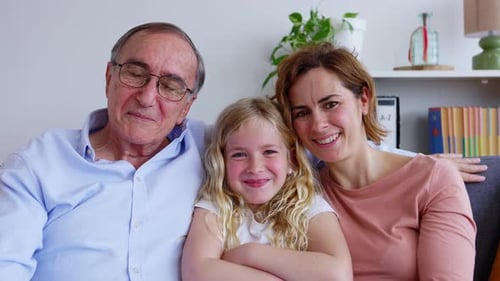 Cheerful Portrait of Little Cute Girl with Her Grandfather and Mother at Home