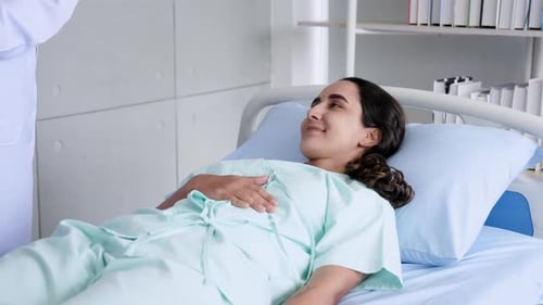 Hispanic woman lying in a hospital bed to do physical therapy Testing breathing in and out From the
