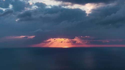 Luftbild, das bei Sonnenuntergang durch Gewitterwolken fliegt