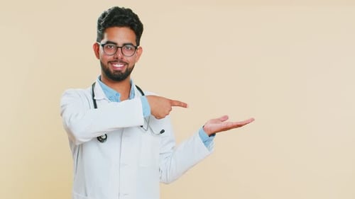 Doctor Man Showing Thumbs Up and Pointing on Blank Space Place for Advertisement Promotion Logo