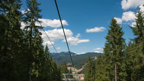 Empty Ski Lift Seats in Alpine Summer Landscape