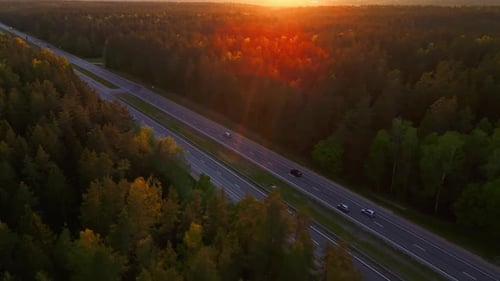 An Aerial View Beautifully Captures a Peaceful Sunset Over an Isolated Highway Winding Through a