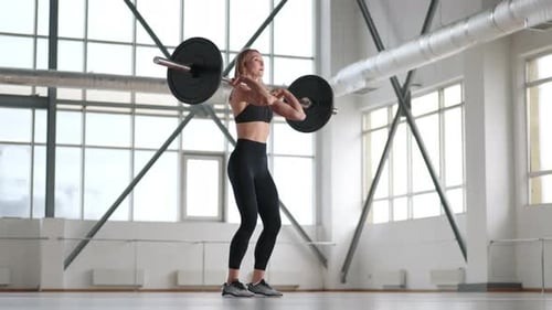 Professional Female Powerlifter Looks Dedicated and Serious