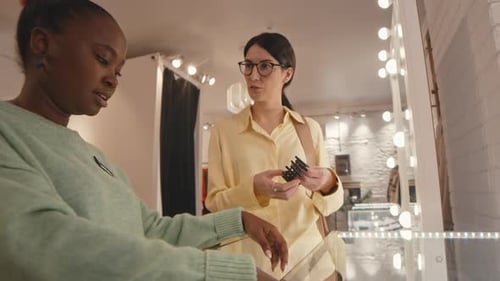 Young Woman Choosing Accessory in Expensive Showroom