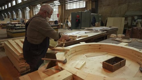 A Skilled Craftsman Works in a Woodworking Shop Creating Stunning Pieces of Art Stock Clip
