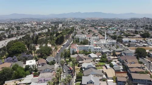 Aerial drone view over neighborhood, park and pond, in sunny Los Angeles, USA