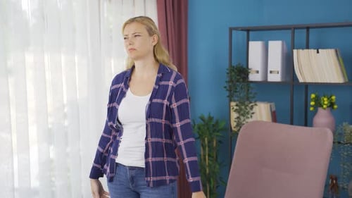 Woman Stands Thinking Deeply in Bright Indoor Setting