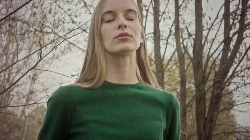 Model posing for photoshoot in autumn forest