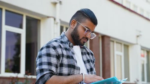 Indian Student Reading Book in College Campus