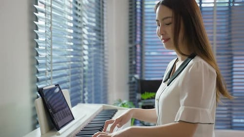 Woman Playing Piano at Home