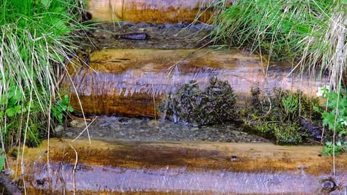 Clear water from the mountain streams into a man-made path for the people to get water to drink.