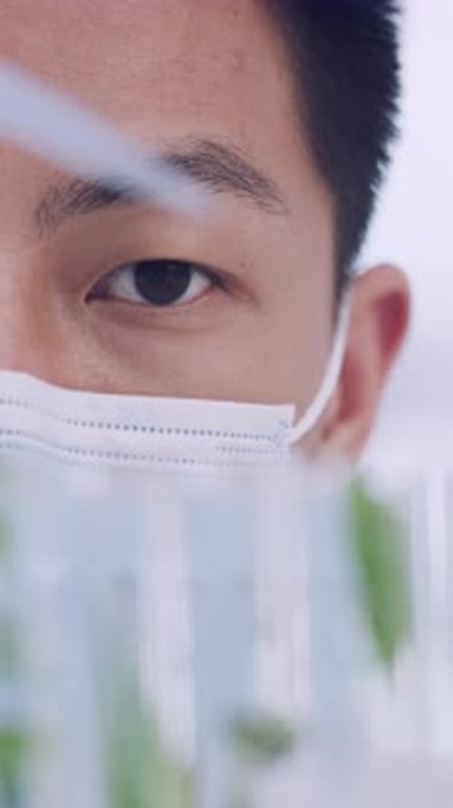 Young Man Scientist with Pipette and Test Tubes