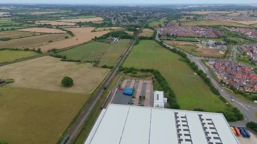 Aerial View of UK Suburban Development and Fields