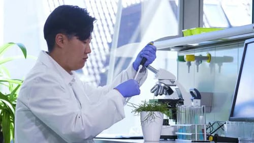 Scientist Uses Pipette in Modern Lab Setting