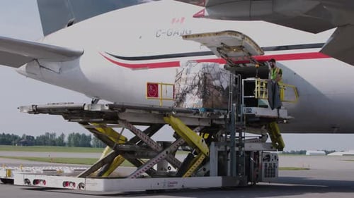 Cargo Lift Loading Airplane with Worker on Platform