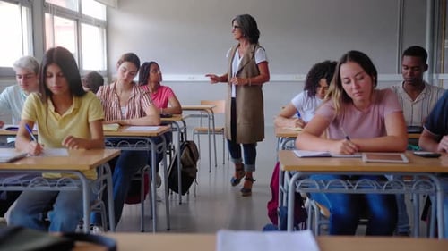 Students Listening to Teacher in Bright Classroom