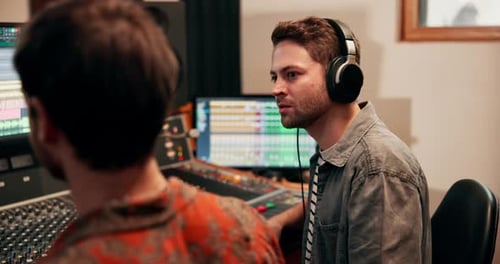 Studio, teamwork or male producer with headphones for listening, hearing