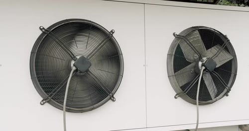 Industrial Ventilation Fans Spinning on White Wall