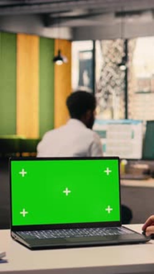 Vertical Video Green Screen Mockup on Laptop with Woman Working at Office Desk
