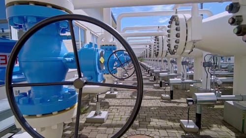 Row of Large Blue Valves on a Natural Gas Pipeline at a Pumping Facility