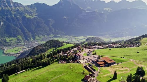 Scenic view of lush alpine valley with majestic mountain backdrop. Flumserberg, Switzerland