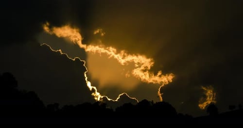 Golden Sunlight Streaming Through Dark Clouds