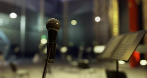 Microphone Ready for Performance in an Empty Concert Hall at Night