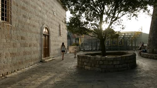 Woman with child walking around European city