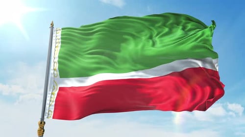 Waving Green White Red Flag with Ornamental Hoist Against Blue Sky