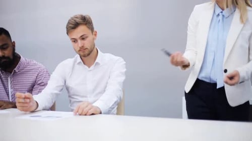 Business Team Attending Presentation in Modern Office