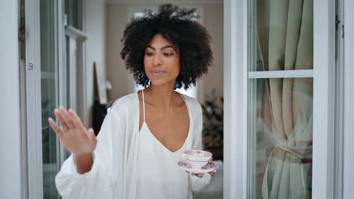 Curly Woman Touching Rain at Window