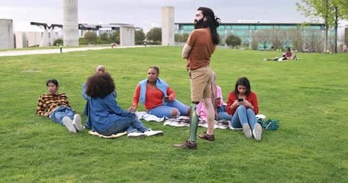 Young diverse friends share laughter and joy together at city park this summer