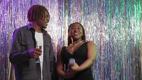 Happy Young Adults Celebrate with Confetti and Champagne