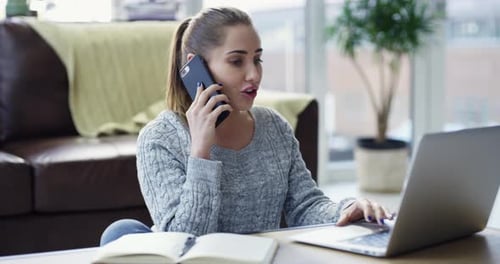 Woman Talking on Phone While Using Laptop