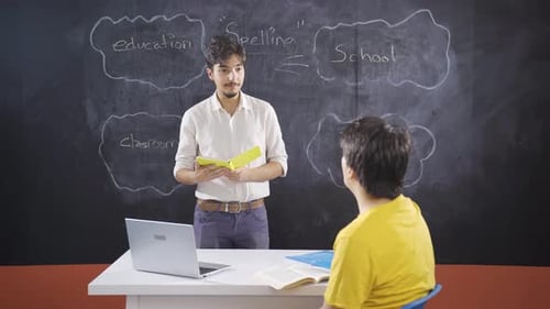 Teacher Helping Student in a Classroom Setting